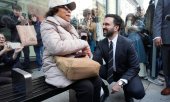 Mamdani chats to a person at a bus stop. (© picture alliance / ASSOCIATED PRESS / Seth Wenig)