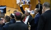 Israel's National Security Minister Itamar Ben-Gvir (centre) and members of the Knesset celebrate after the Knesset passed the law. (© AP Photo/Itay Cohen)