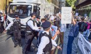 Protesters gathered around the vehicle transporting the convicted activists on 18 July. (© picture alliance / ZUMAPRESS.com / Vuk Valcic)